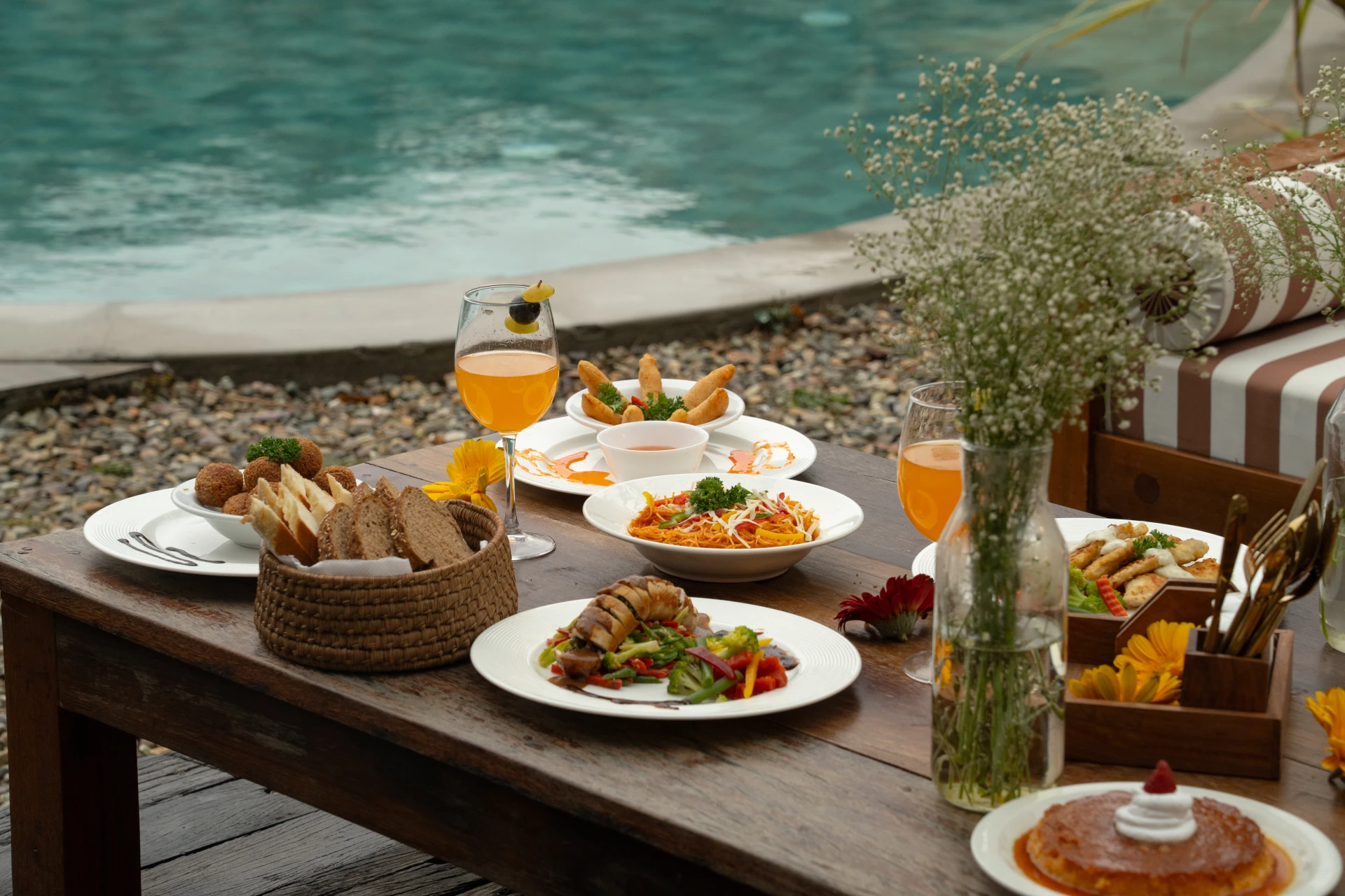 Poolside dining with gourmet platters and cocktails by the pool