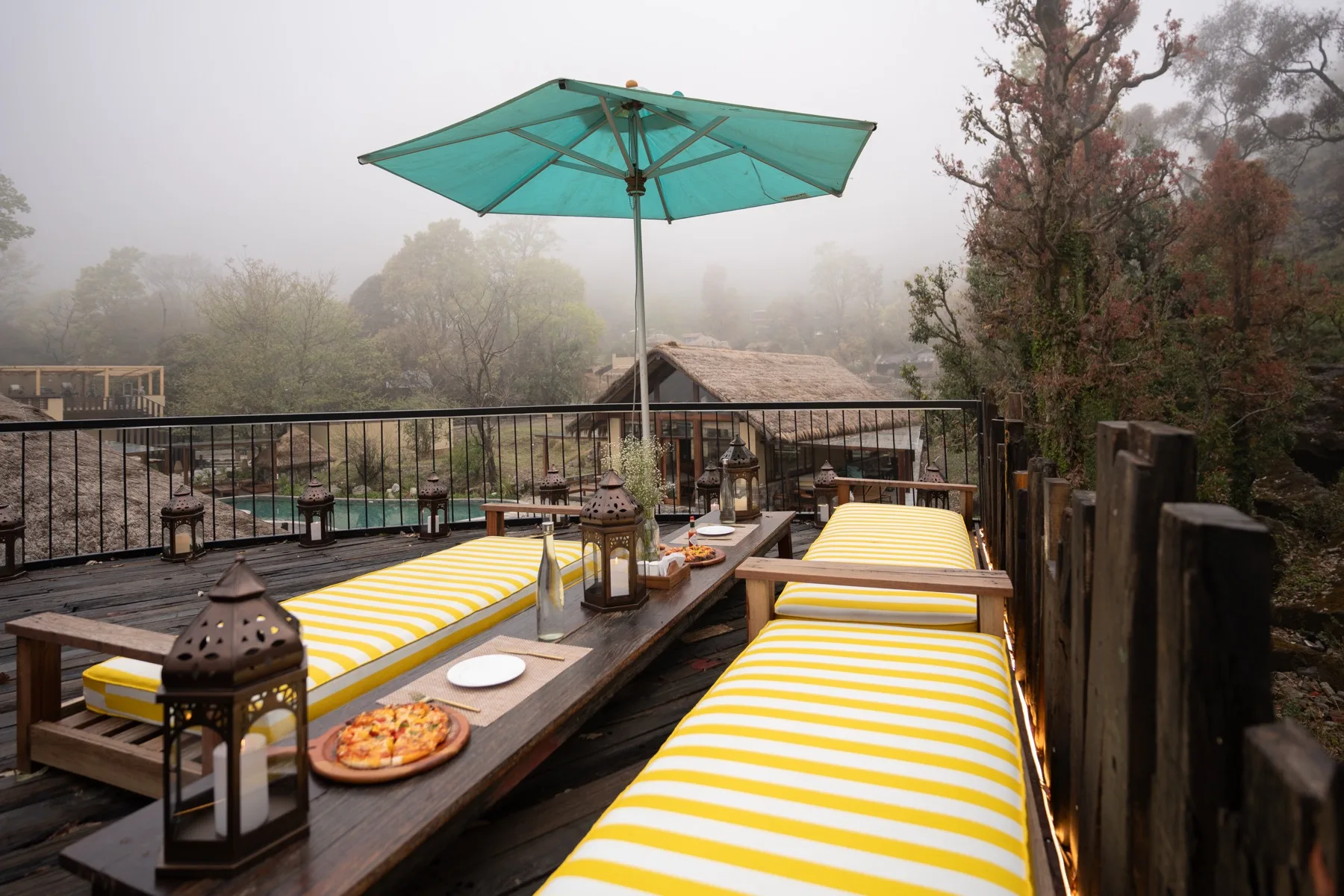 Pizza on a yellow striped daybed deck at Kaansya overlooking the misty hills